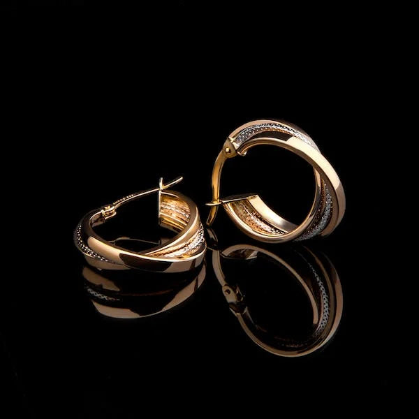 Golden bronze like earring jewelry on black background